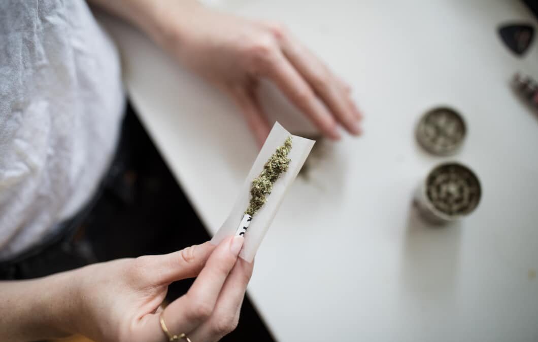 Photo of person rolling cannabis