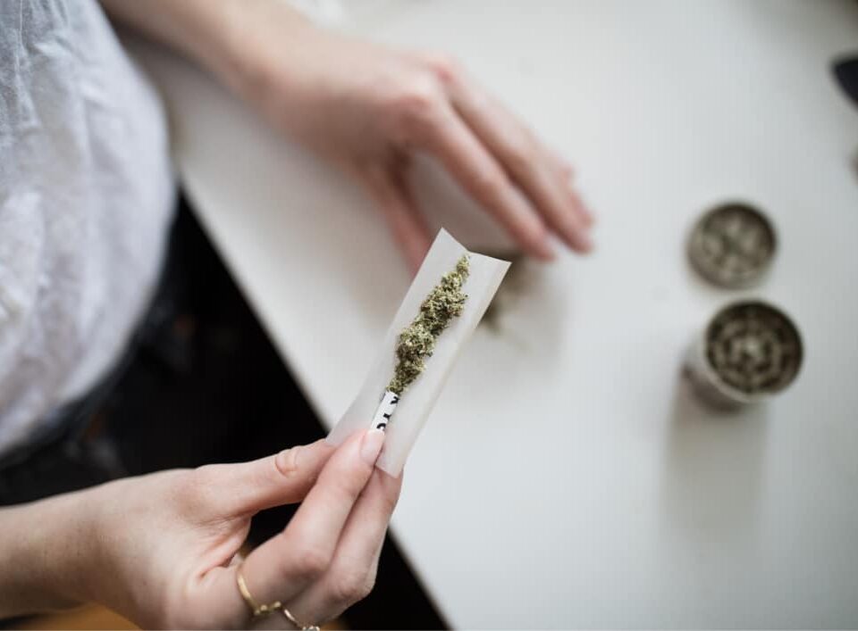 Photo of person rolling cannabis