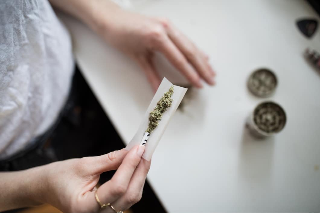 Photo of person rolling cannabis