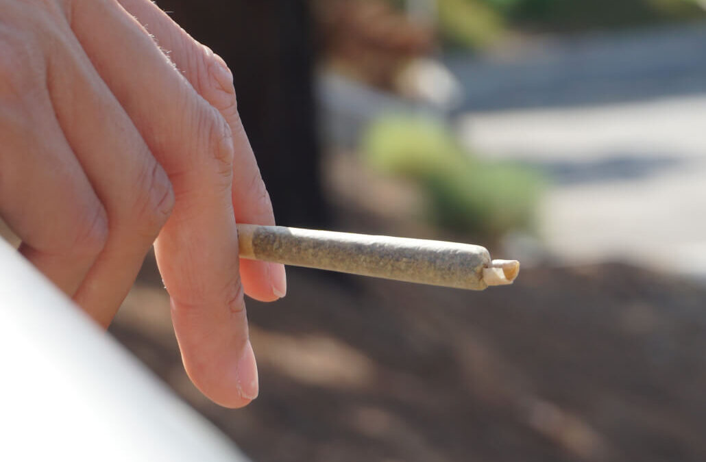 A person smoking cannabis in an outdoor cannabis consumption space