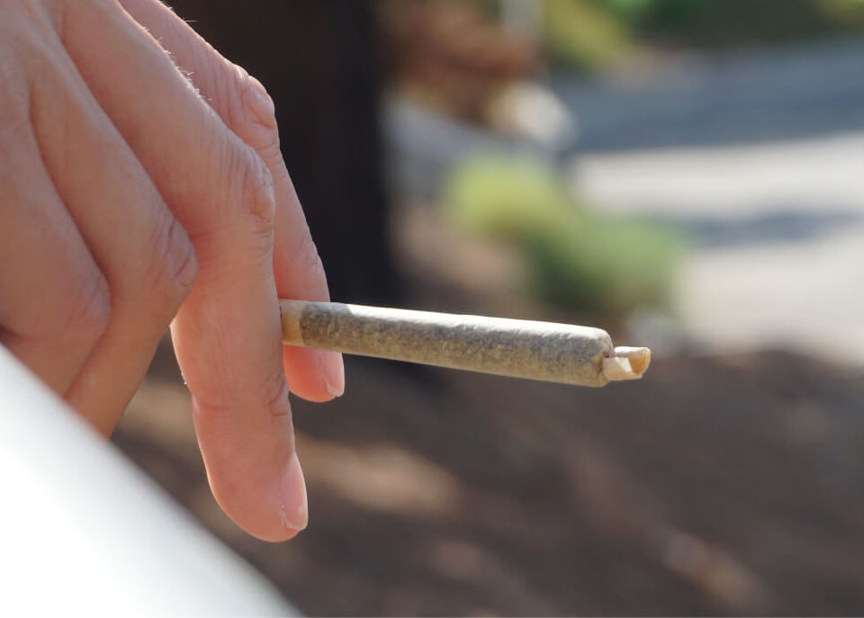 A person smoking cannabis in an outdoor cannabis consumption space