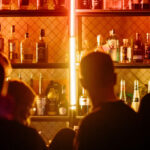 Bar employees and customers at service bar