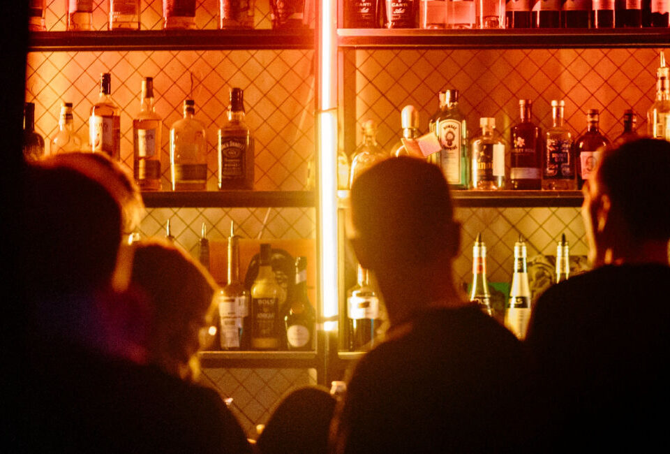 Bar employees and customers at service bar