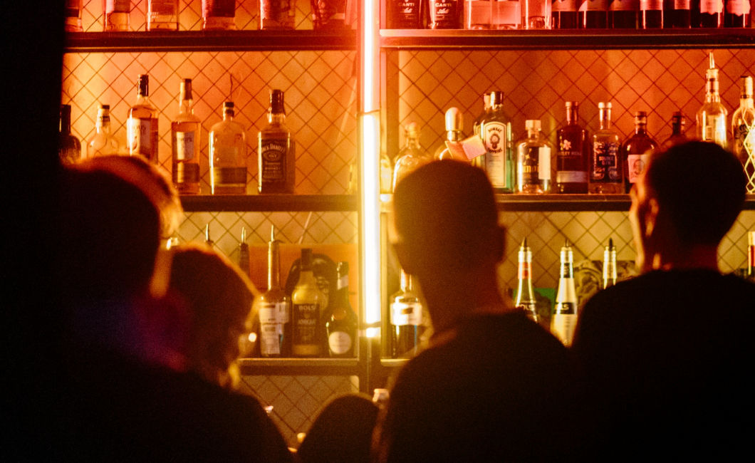 Bar employees and customers at service bar