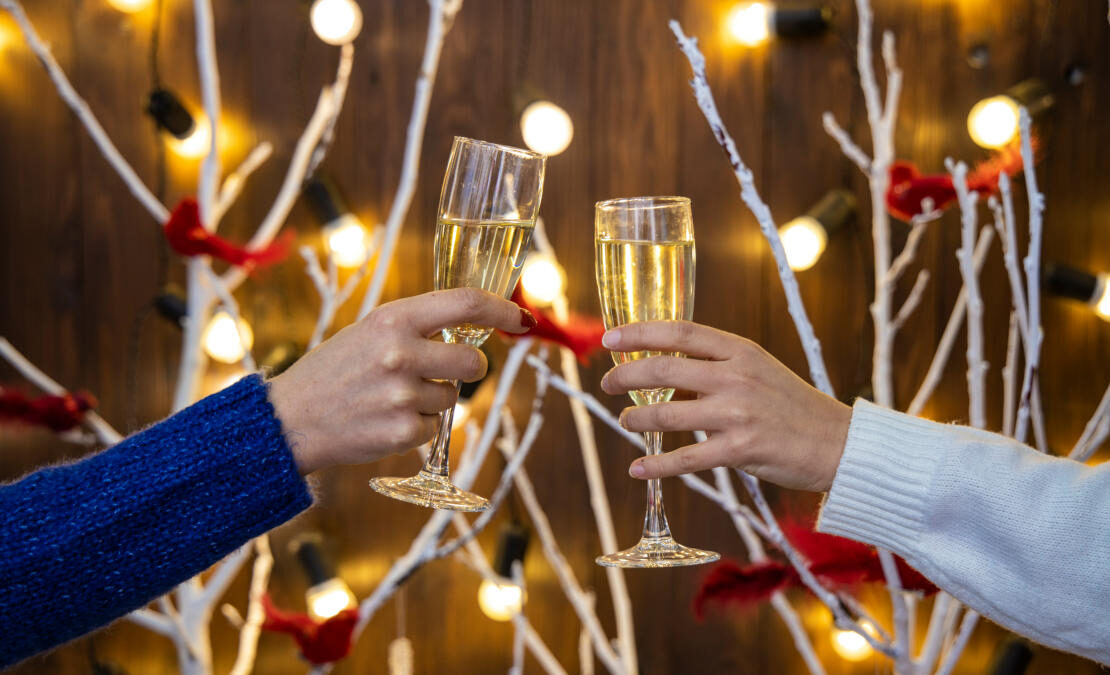 Two people toasting with champagne glasses