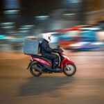 Person delivering liquor on scooter