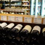 Liquor store interior showing wine on racks and beer in fridges