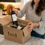 A person unpacking a box of wine ordered from another province under the DTC liquor sales agreement